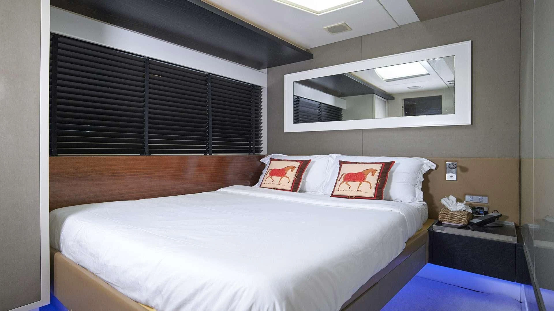 a bed with white sheets and pillows aboard FUNKY TOWN Yacht for Sale