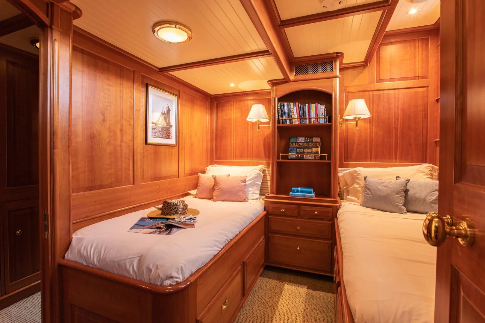 a room with a bed and a bookcase aboard AUDREY II Yacht for Sale