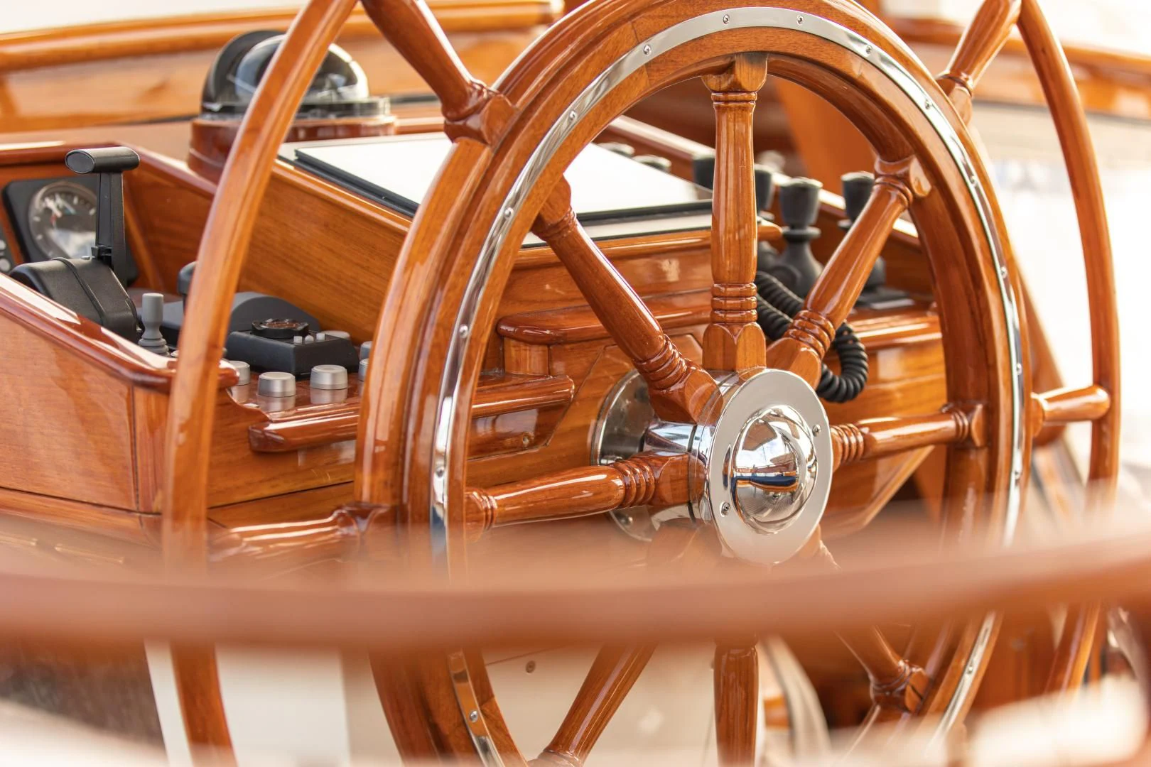 a wooden wheel with a wooden steering wheel aboard AUDREY II Yacht for Sale