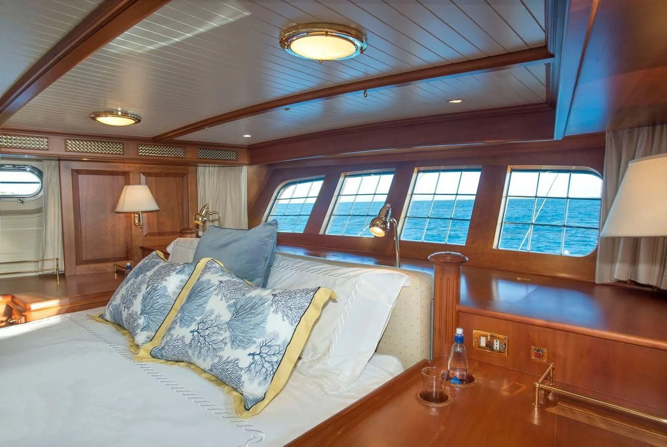 a room with a bed and a table aboard AUDREY II Yacht for Sale