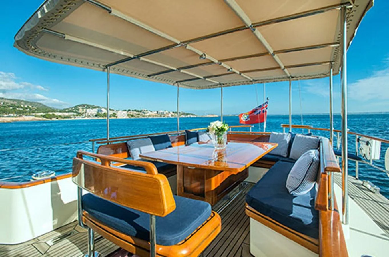 a table and chairs on a boat aboard AUDREY II Yacht for Sale