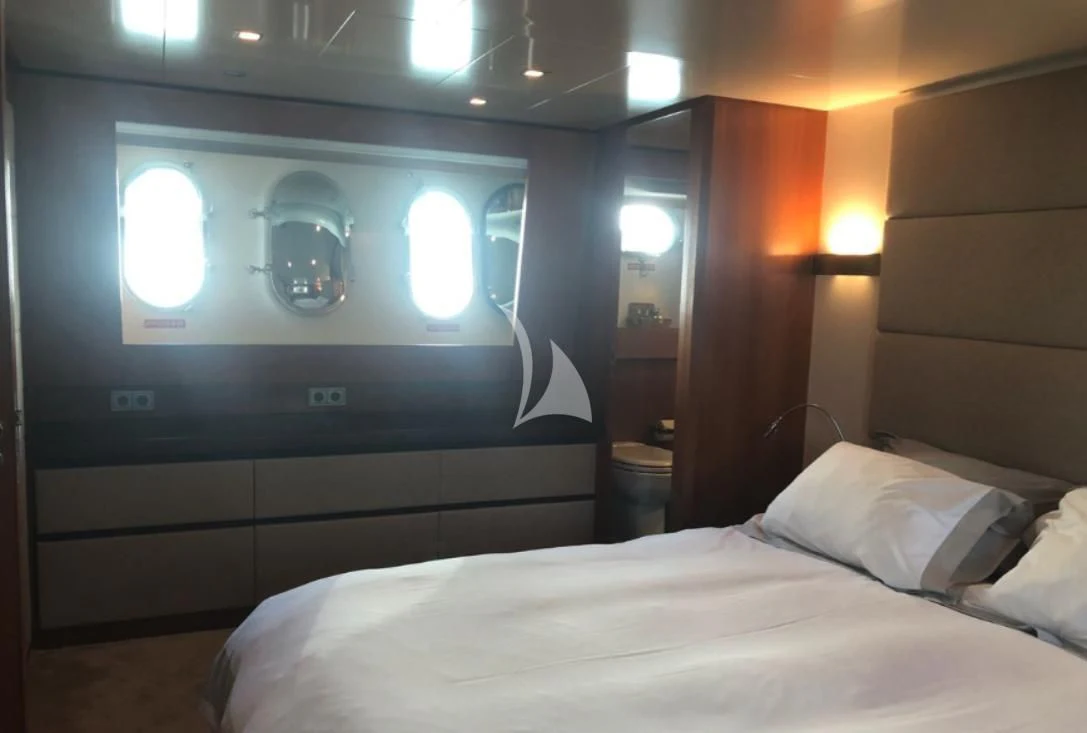 a bed with a white bed and a large round mirror aboard OCEAN DELTA 11 Yacht for Sale