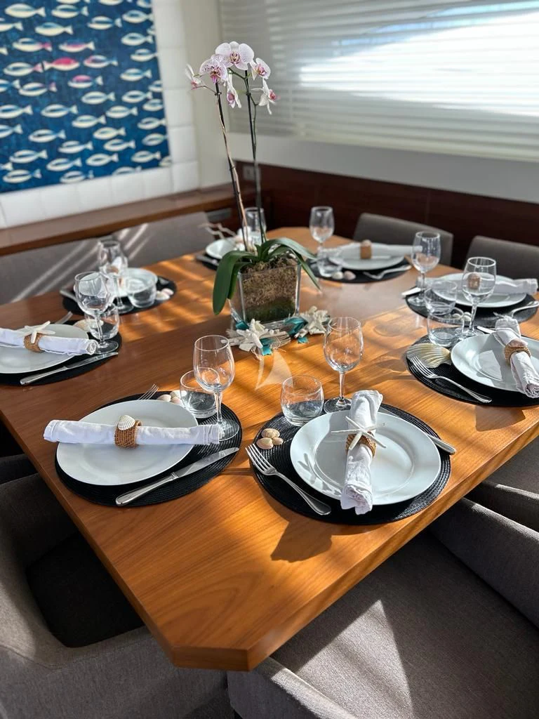 a table with plates and glasses aboard OCEAN DELTA 11 Yacht for Sale