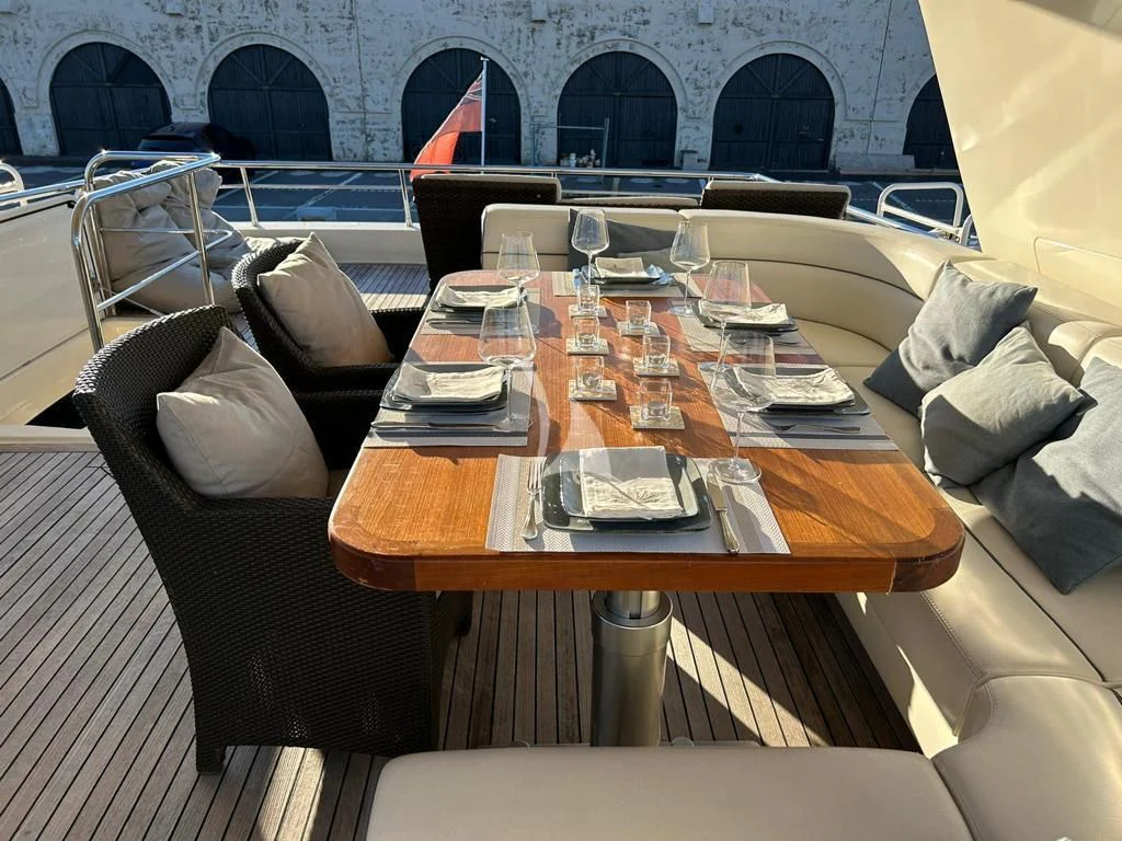 a table with chairs and a couch aboard OCEAN DELTA 11 Yacht for Sale