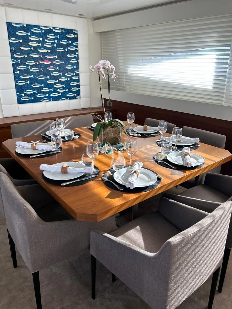a table with plates and glasses on it aboard OCEAN DELTA 11 Yacht for Sale