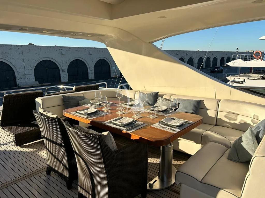 a table with chairs and a large window overlooking a body of water aboard OCEAN DELTA 11 Yacht for Sale