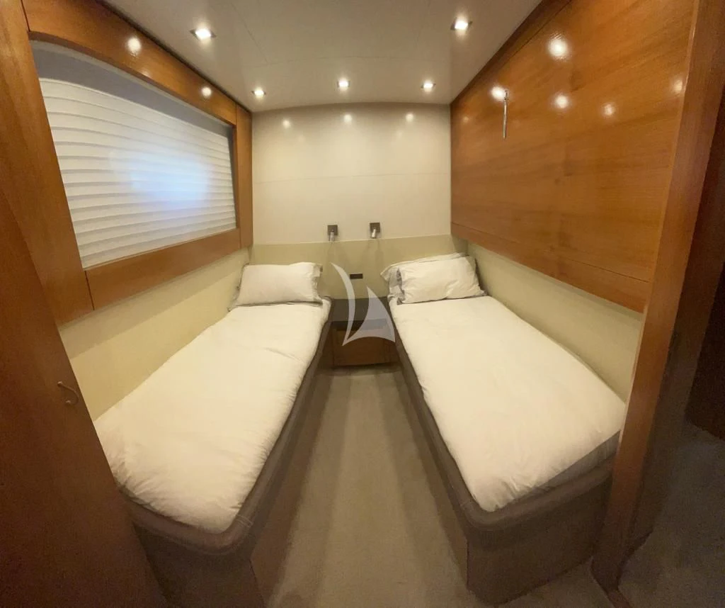 a room with a bed and a table aboard OCEAN DELTA 11 Yacht for Sale