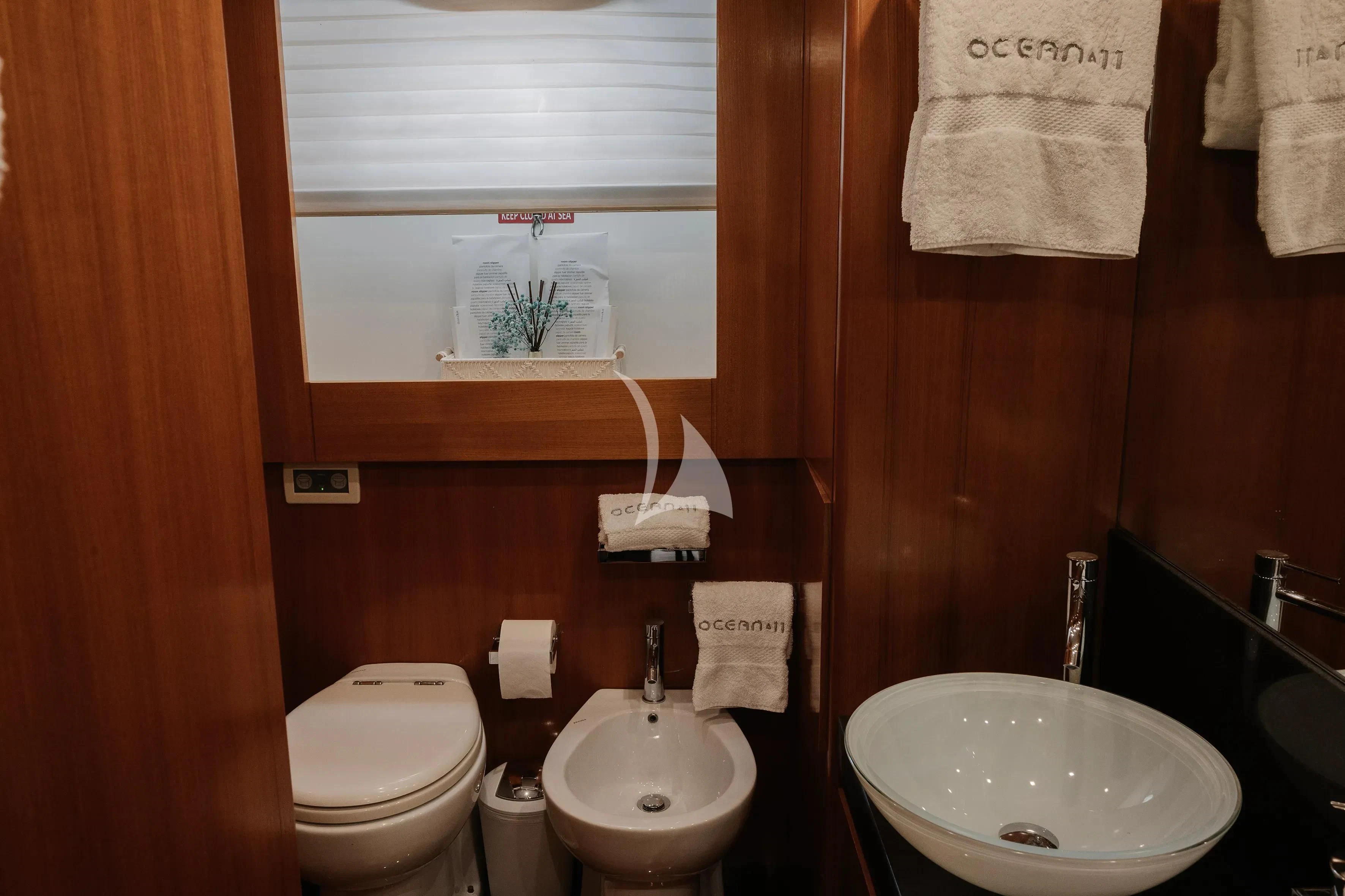 a bathroom with a toilet and sink aboard OCEAN DELTA 11 Yacht for Sale
