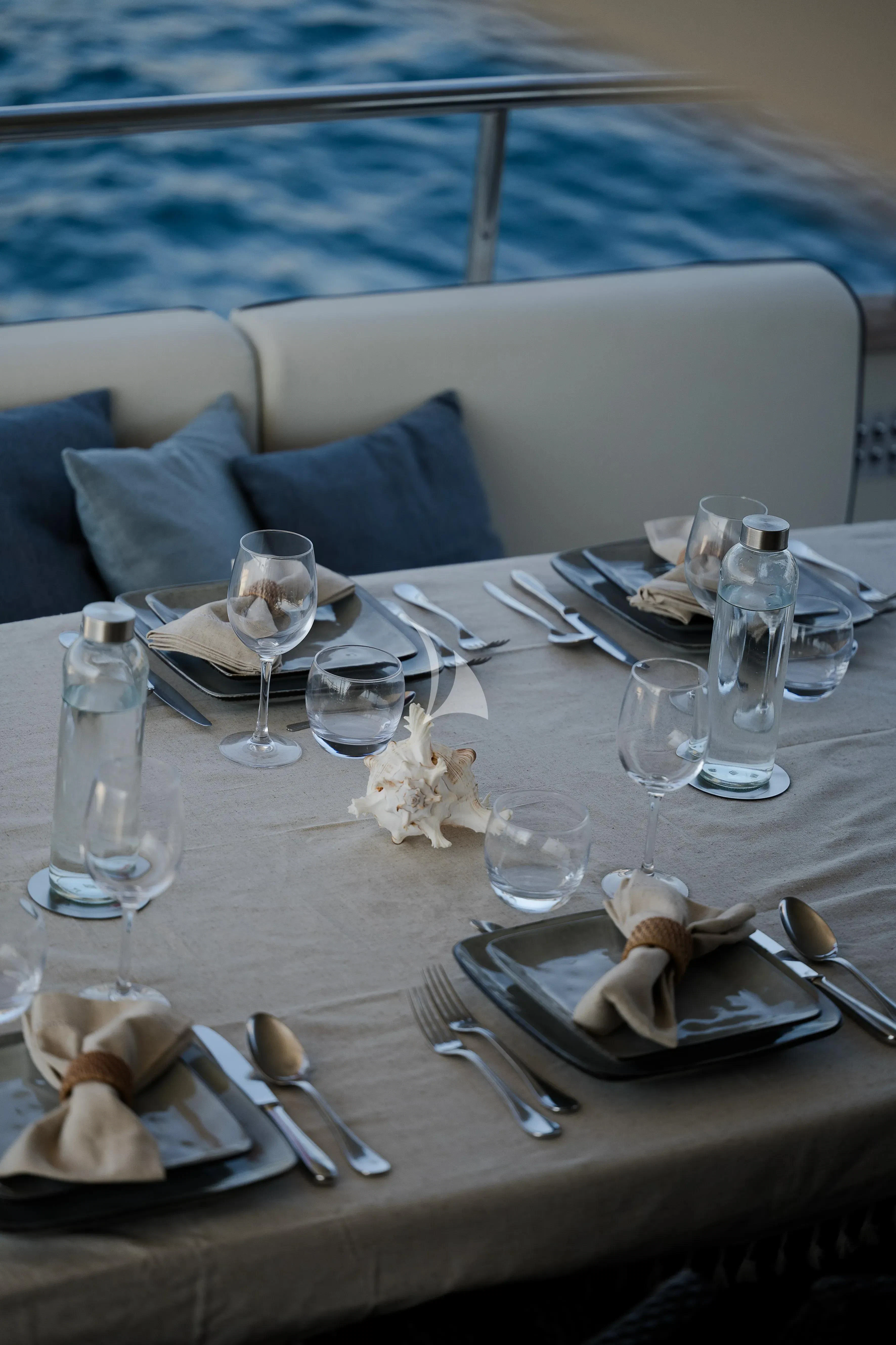 a table with plates and glasses on it aboard OCEAN DELTA 11 Yacht for Sale