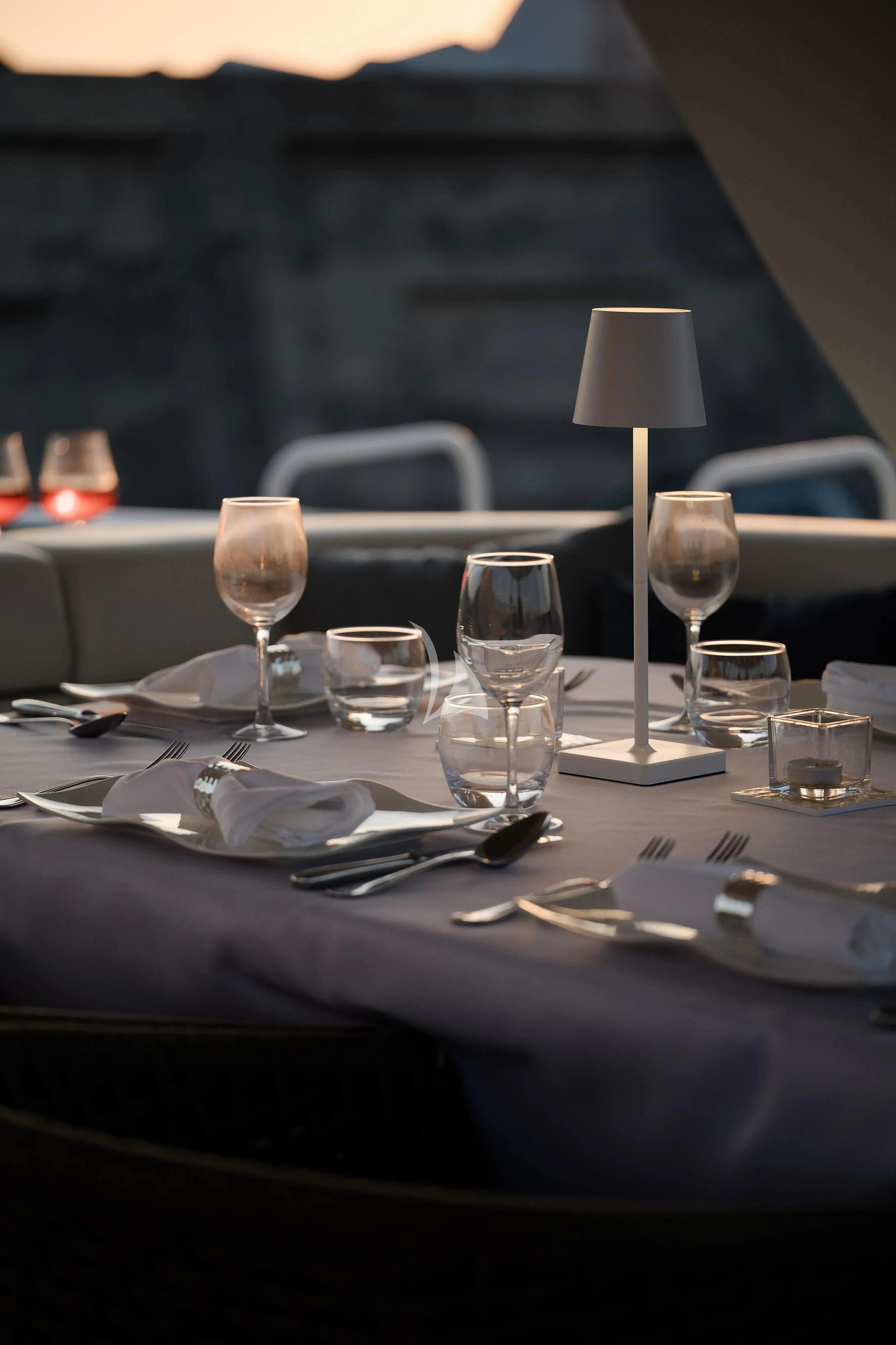 a table with plates and glasses on it aboard OCEAN DELTA 11 Yacht for Sale
