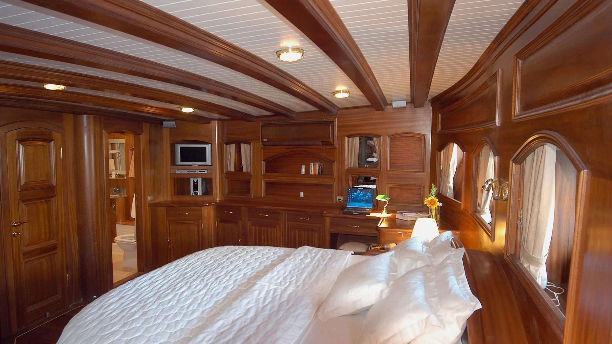 a bedroom with wood walls aboard QUEEN OF KARIA Yacht for Sale