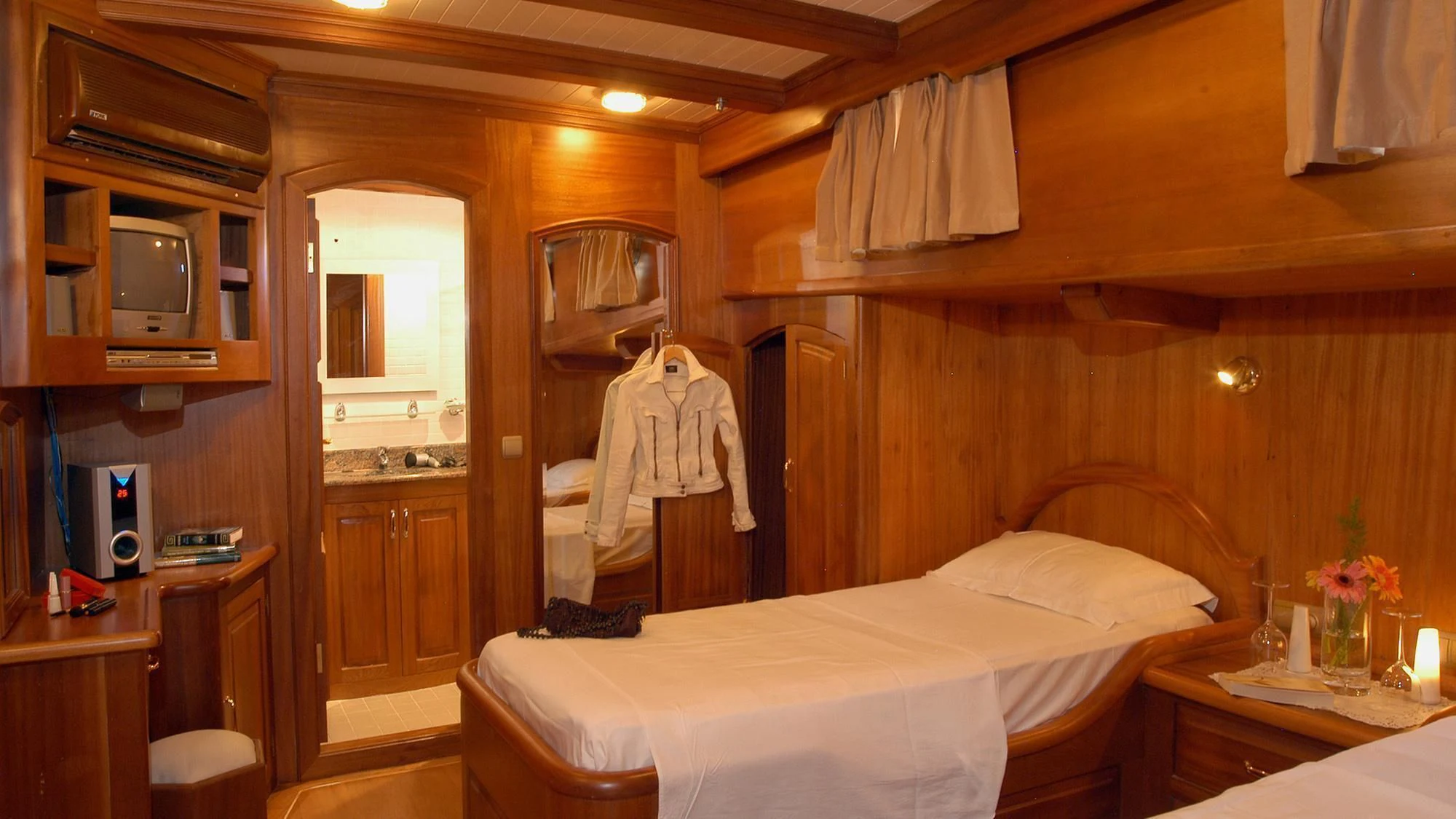 a room with a bed and a mirror aboard QUEEN OF KARIA Yacht for Sale