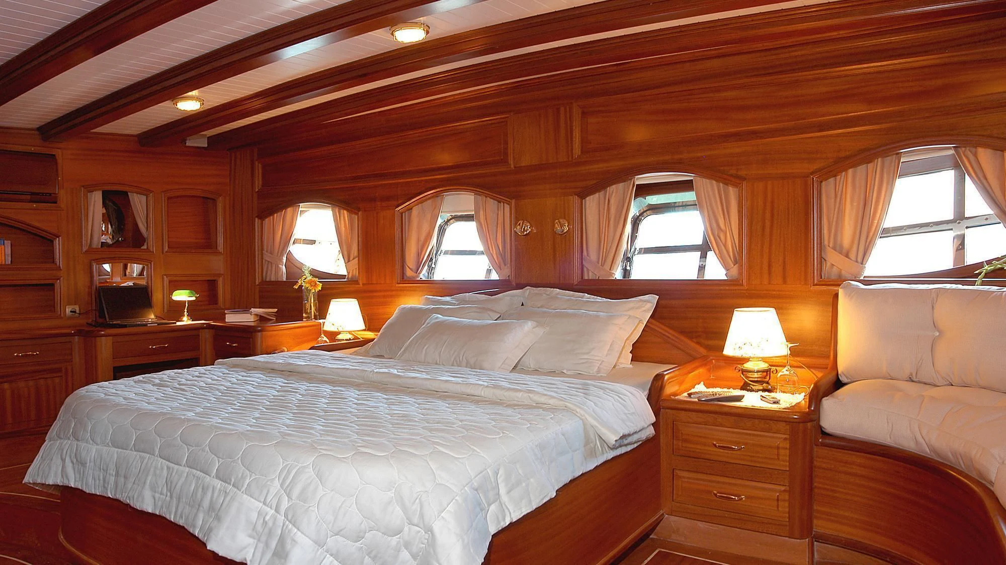 a bedroom with a bed and a couch aboard QUEEN OF KARIA Yacht for Sale
