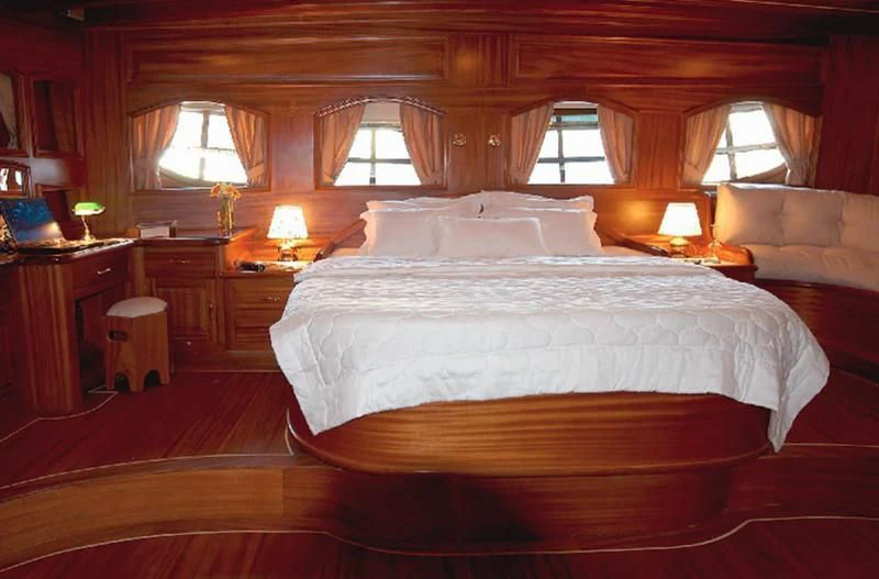 a bed with lamps on either side of it aboard QUEEN OF KARIA Yacht for Sale
