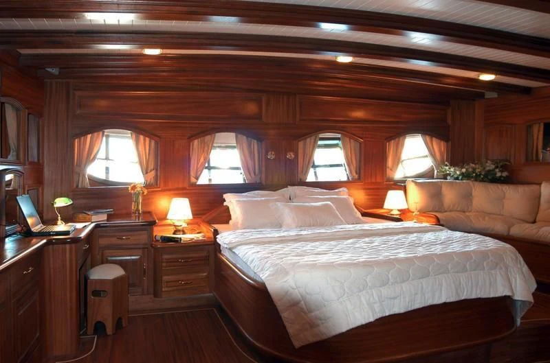 a room with a bed and a couch aboard QUEEN OF KARIA Yacht for Sale