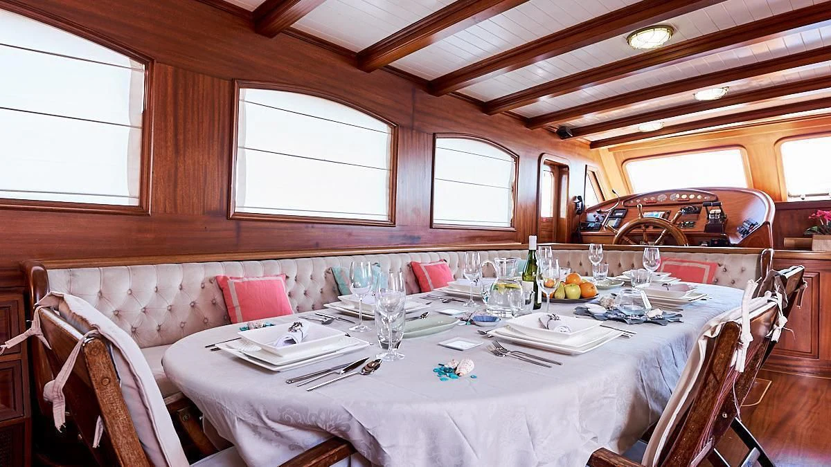 a dining table set for a meal aboard QUEEN OF KARIA Yacht for Sale