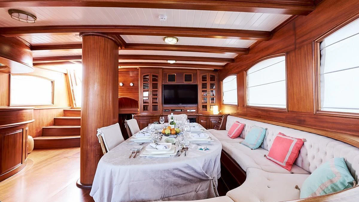 a room with a table and chairs aboard QUEEN OF KARIA Yacht for Sale