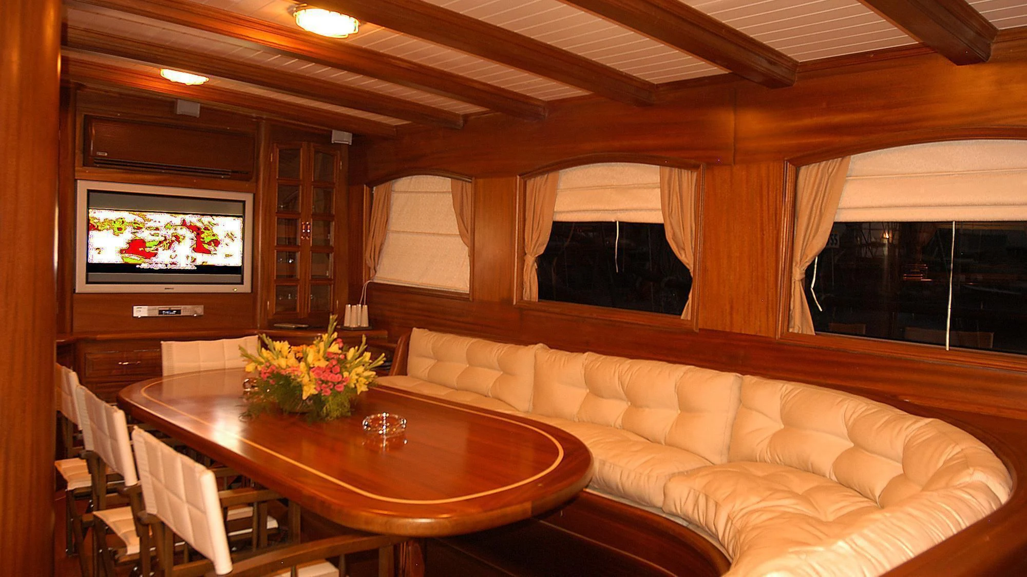 a living room with a table and couches aboard QUEEN OF KARIA Yacht for Sale