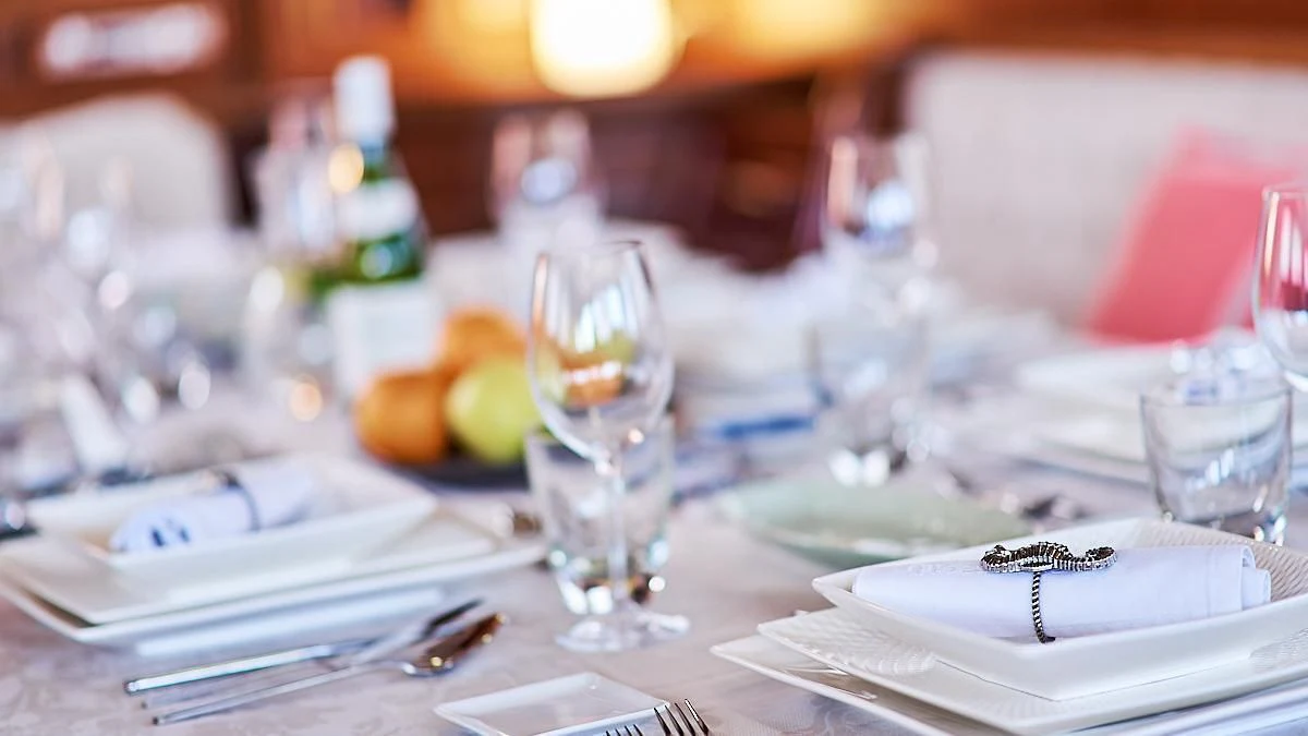 a table with plates and glasses aboard QUEEN OF KARIA Yacht for Sale