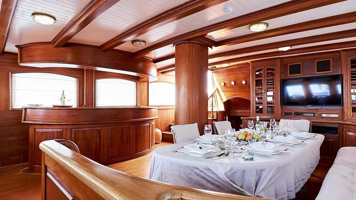 a room with a table and chairs aboard QUEEN OF KARIA Yacht for Sale