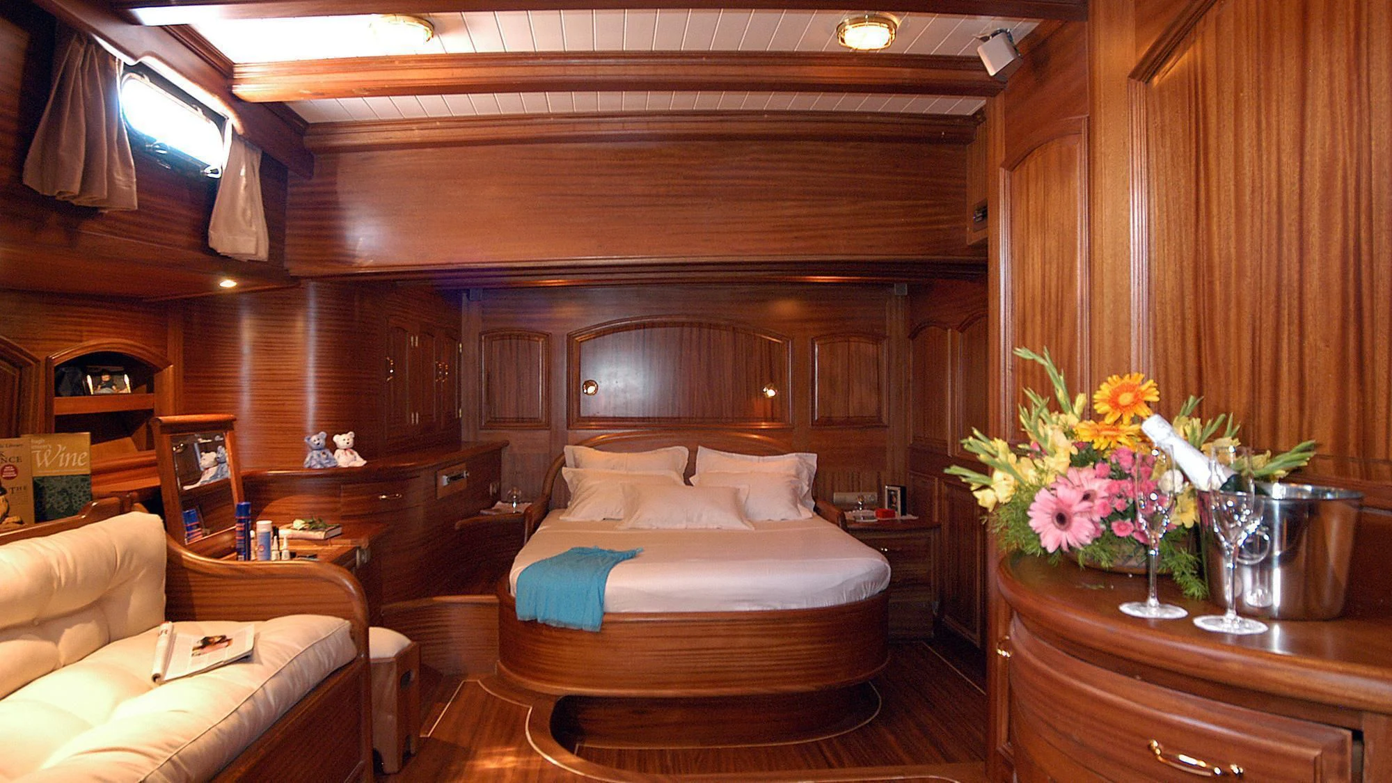 a room with a bed and a table aboard QUEEN OF KARIA Yacht for Sale
