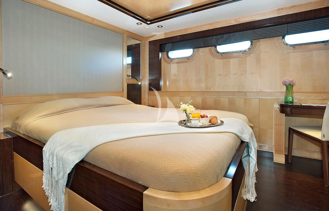 a room with a bed and a table aboard CHRISTINA G Yacht for Charter