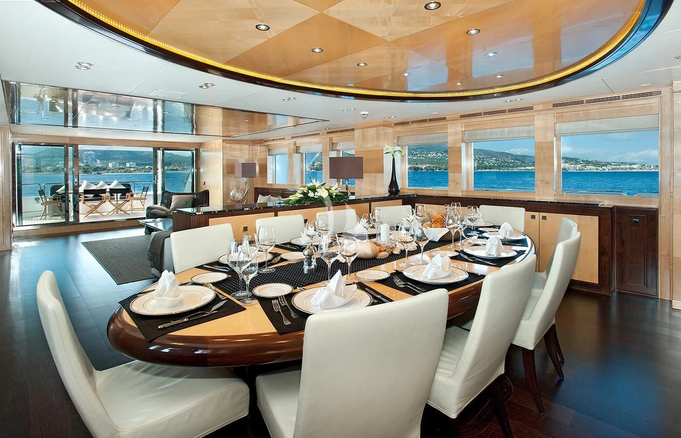 a large dining room with a large table and chairs aboard CHRISTINA G Yacht for Charter