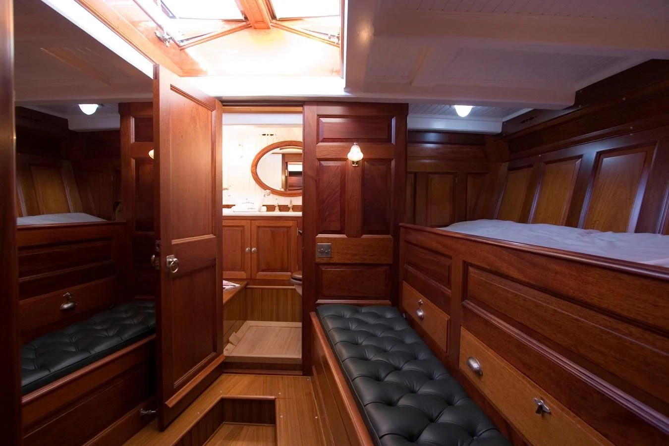 a room with a bed and a mirror aboard MOONBEAM OF FIFE III Yacht for Sale