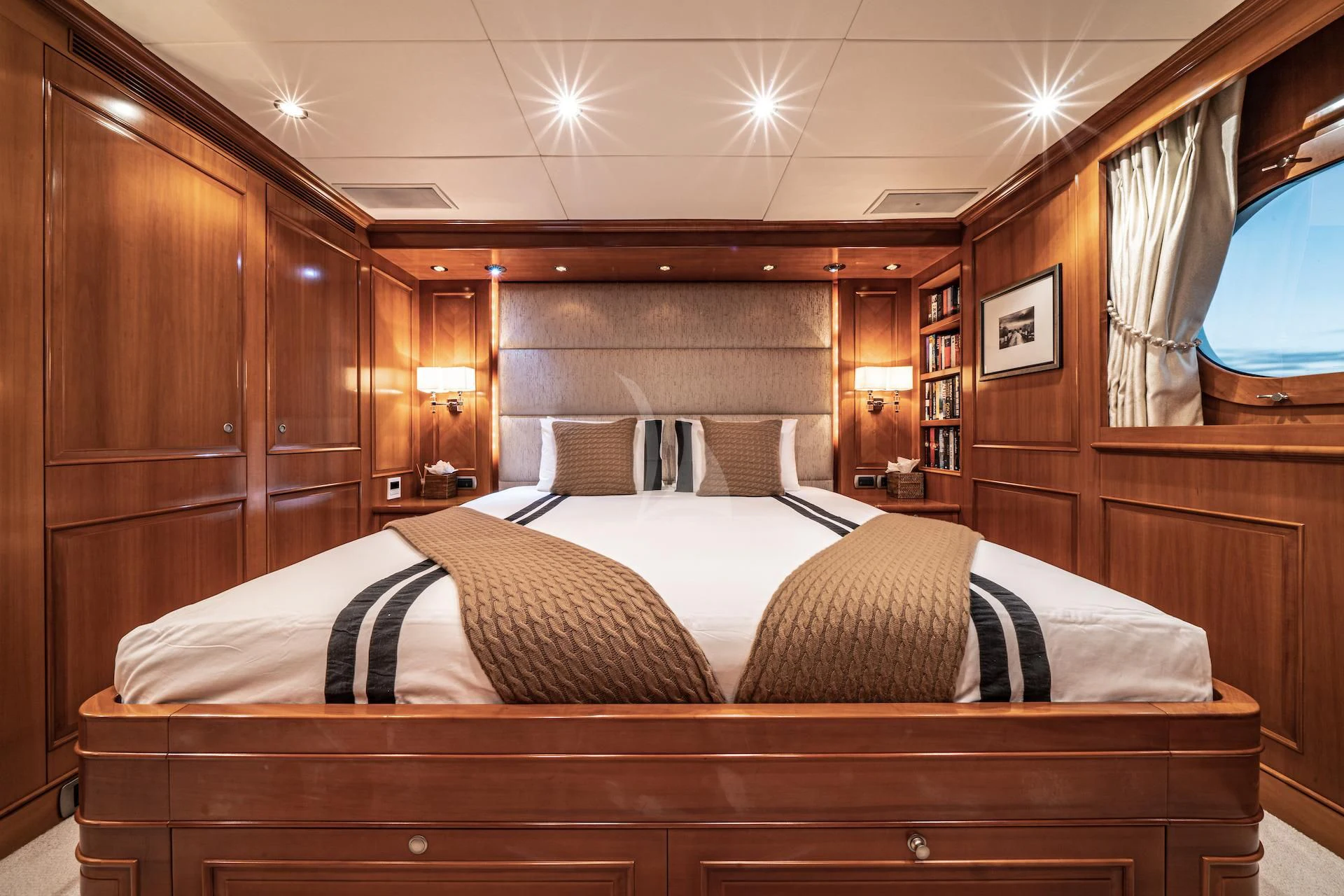 a room with a bed and a wood cabinet aboard RELENTLESS Yacht for Sale