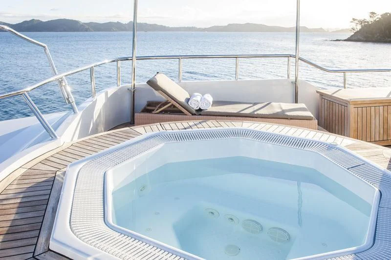 a deck with a chair on it and water in the background aboard RELENTLESS Yacht for Sale
