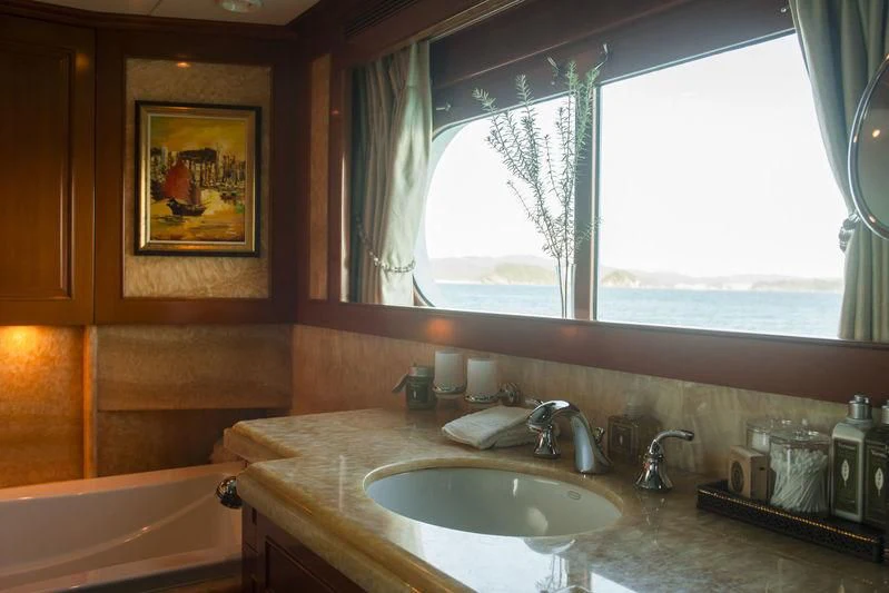 a bathroom with a sink and a window aboard RELENTLESS Yacht for Sale