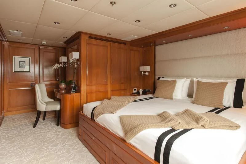 a room with a bed and a desk aboard RELENTLESS Yacht for Sale