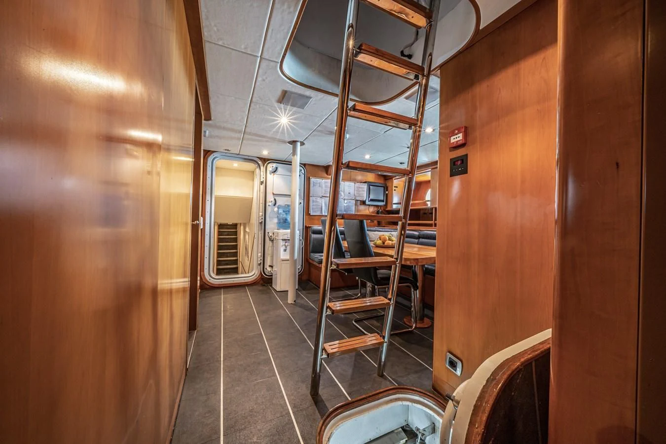 a hallway with a metal railing aboard RELENTLESS Yacht for Sale