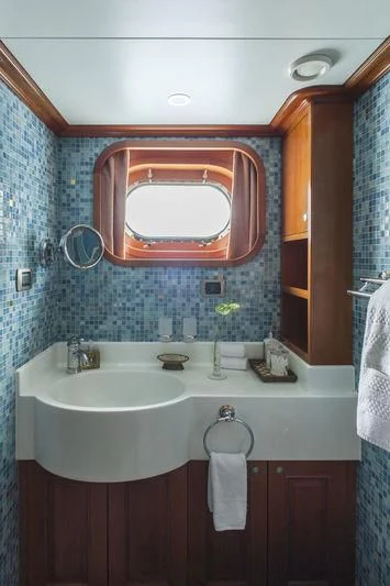 a bathroom with a red mirror aboard RELENTLESS Yacht for Sale