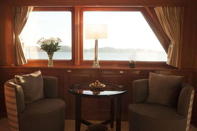 a living room with a table and chairs aboard RELENTLESS Yacht for Sale