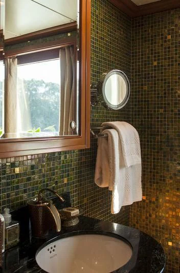 a bathroom with a sink and mirror aboard RELENTLESS Yacht for Sale