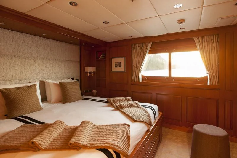 a room with a bed and a window aboard RELENTLESS Yacht for Sale