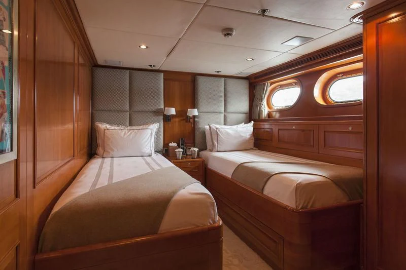 a room with two beds aboard RELENTLESS Yacht for Sale