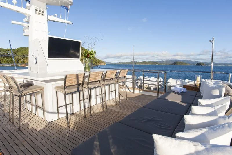 a deck with chairs and a television on it aboard RELENTLESS Yacht for Sale