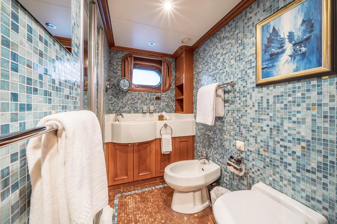 a bathroom with a blue tiled wall aboard RELENTLESS Yacht for Sale