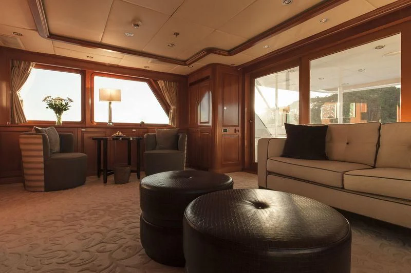 a living room with a couch and a table aboard RELENTLESS Yacht for Sale