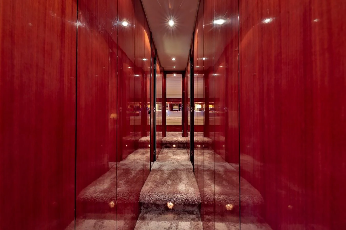 a hallway with red walls aboard NOTORIOUS Yacht for Sale