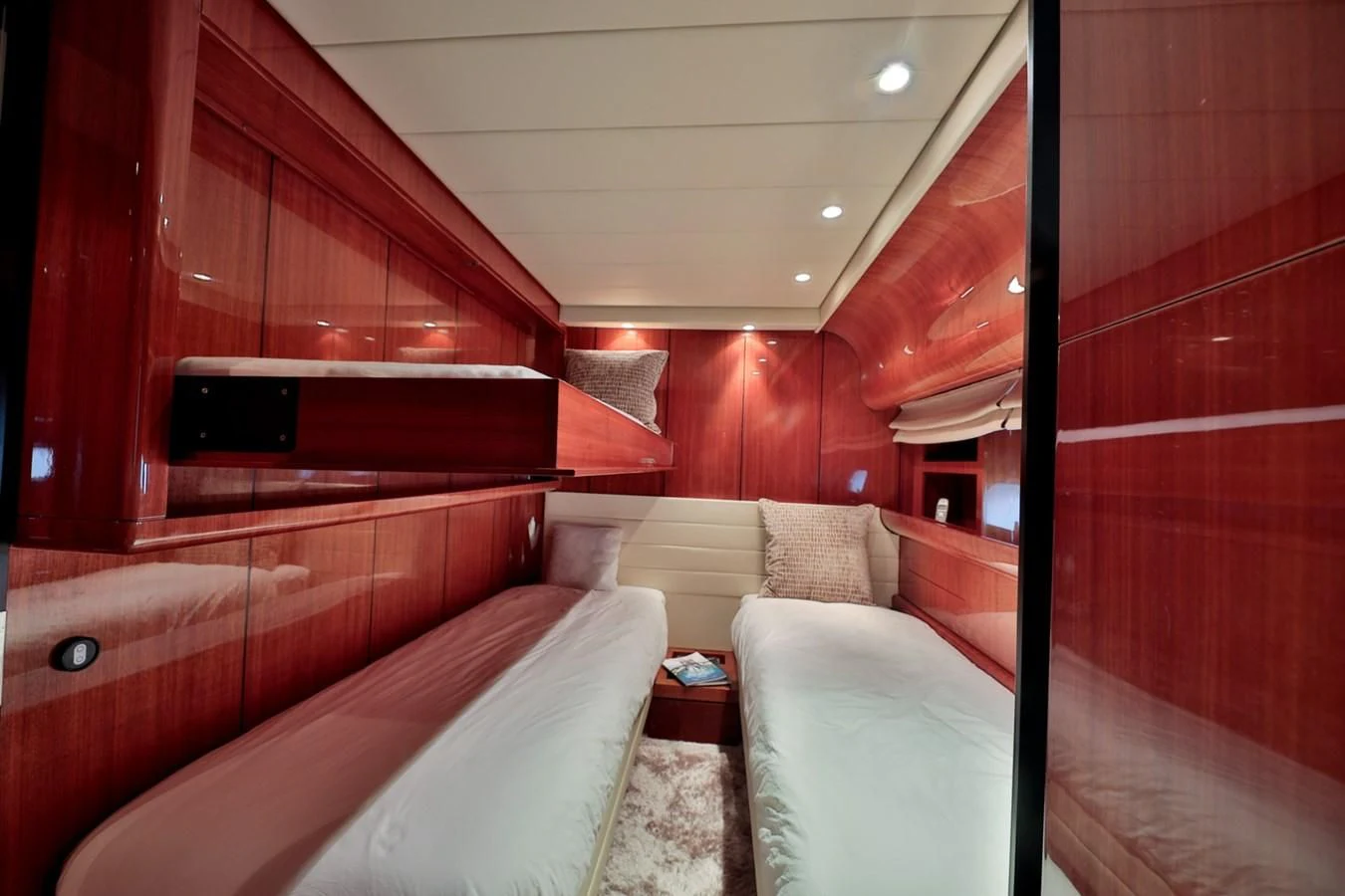 a room with a bed and a television aboard NOTORIOUS Yacht for Sale