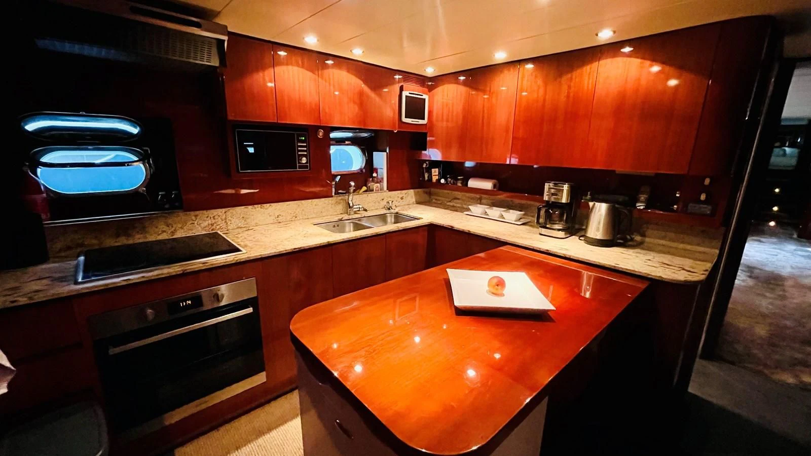 a kitchen with wooden cabinets aboard NOTORIOUS Yacht for Sale