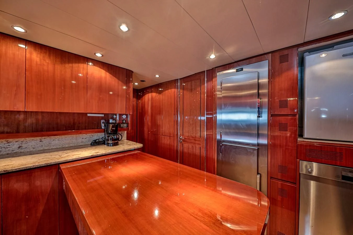 a kitchen with wooden cabinets aboard NOTORIOUS Yacht for Sale