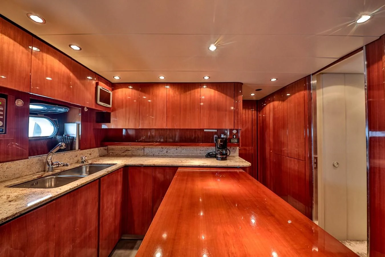 a kitchen with wooden cabinets aboard NOTORIOUS Yacht for Sale