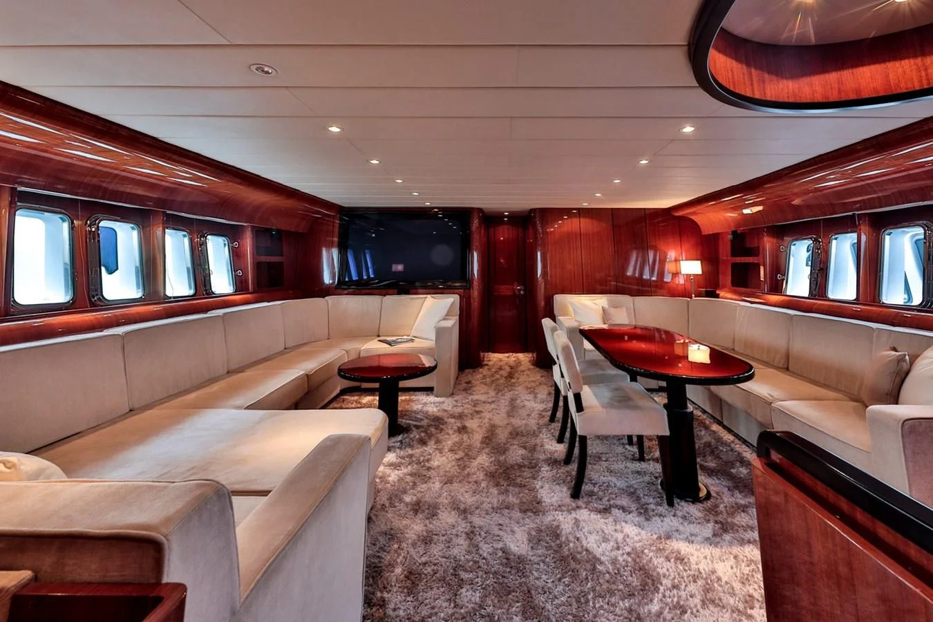 a room with a couch and a table and chairs aboard NOTORIOUS Yacht for Sale