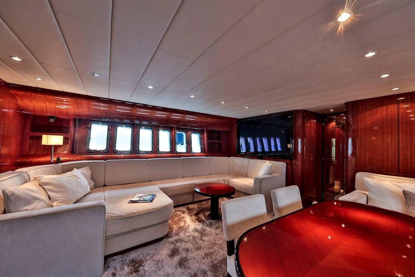 a living room with a couch and a television aboard NOTORIOUS Yacht for Sale