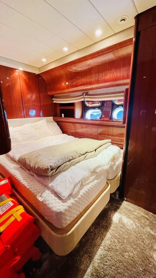 a room with a bed and a mirror aboard NOTORIOUS Yacht for Sale