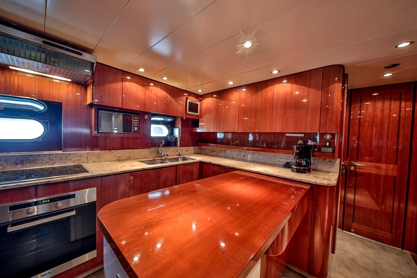 a kitchen with wooden cabinets aboard NOTORIOUS Yacht for Sale